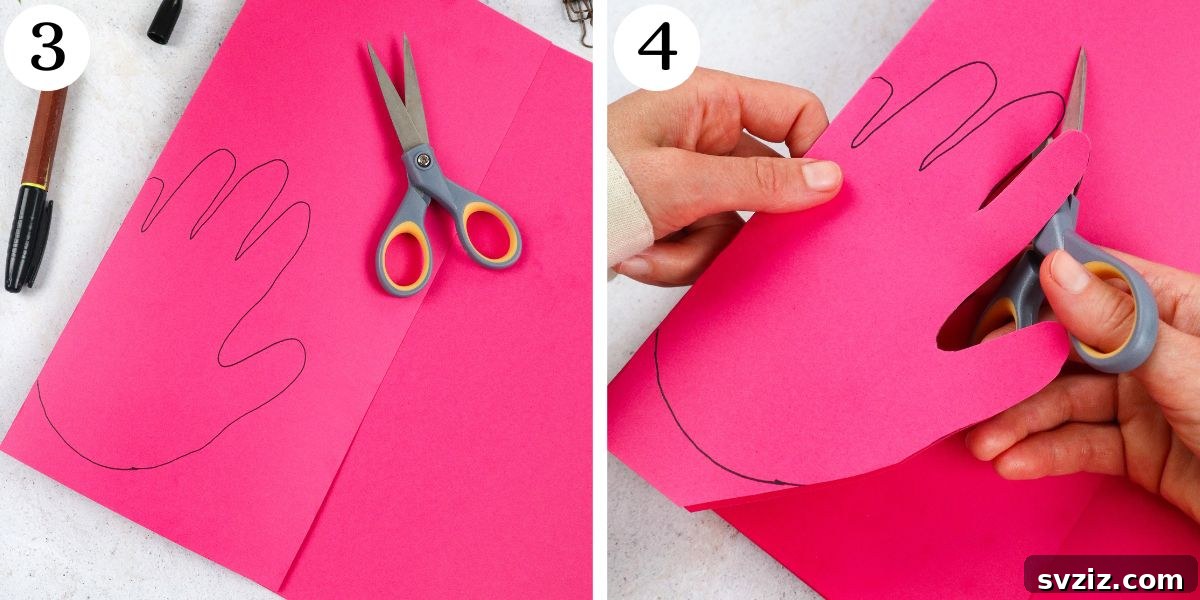 Flamingo Handprint Delight 5 An image showing scissors carefully cutting out a handprint from pink paper, with emphasis on not cutting the folded edge.