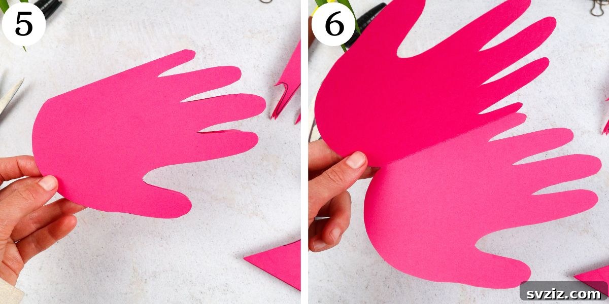 Flamingo Handprint Delight 6 An image showing the cut-out handprint opened up, demonstrating its card-like function, ready to become a flamingo.