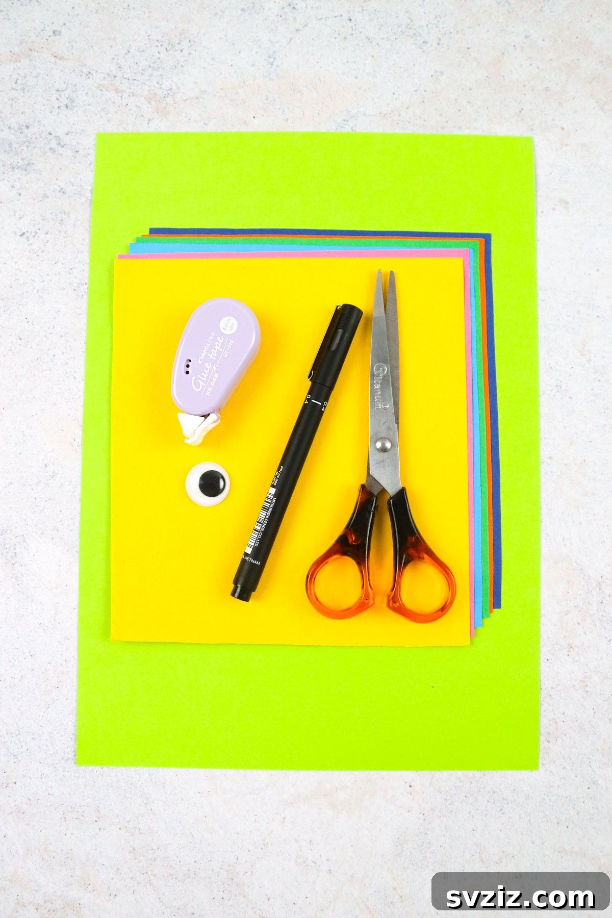 Craft supplies laid out for Handprint Parrots