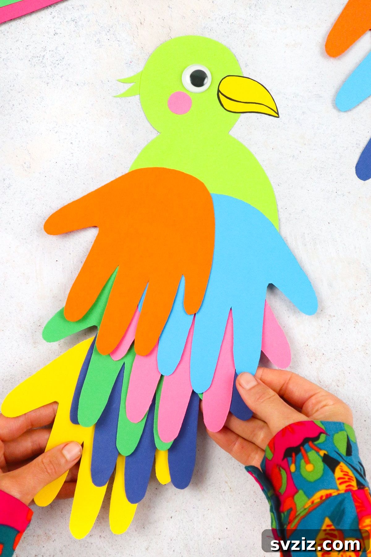 Finished handprint parrot craft for kids