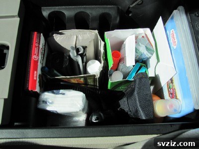 20 Effortless Car Organization Tips 12 Creative DIY car console organizer made from repurposed old tea boxes, perfect for small items.