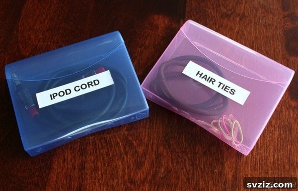 20 Effortless Car Organization Tips 18 Q-tip containers repurposed for organizing small items like hair ties and charging cords in a car.