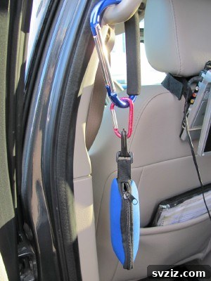 20 Effortless Car Organization Tips 4 Carabiners used as versatile hooks for car organization, showing them holding items in a vehicle.