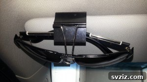 20 Effortless Car Organization Tips 7 Binder clip hack for holding sunglasses on a car visor, a simple and effective storage solution.