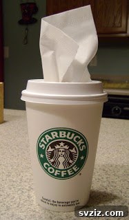 20 Effortless Car Organization Tips 9 Creative paper cup tissue dispenser for a car cup holder, showing tissues neatly stored.