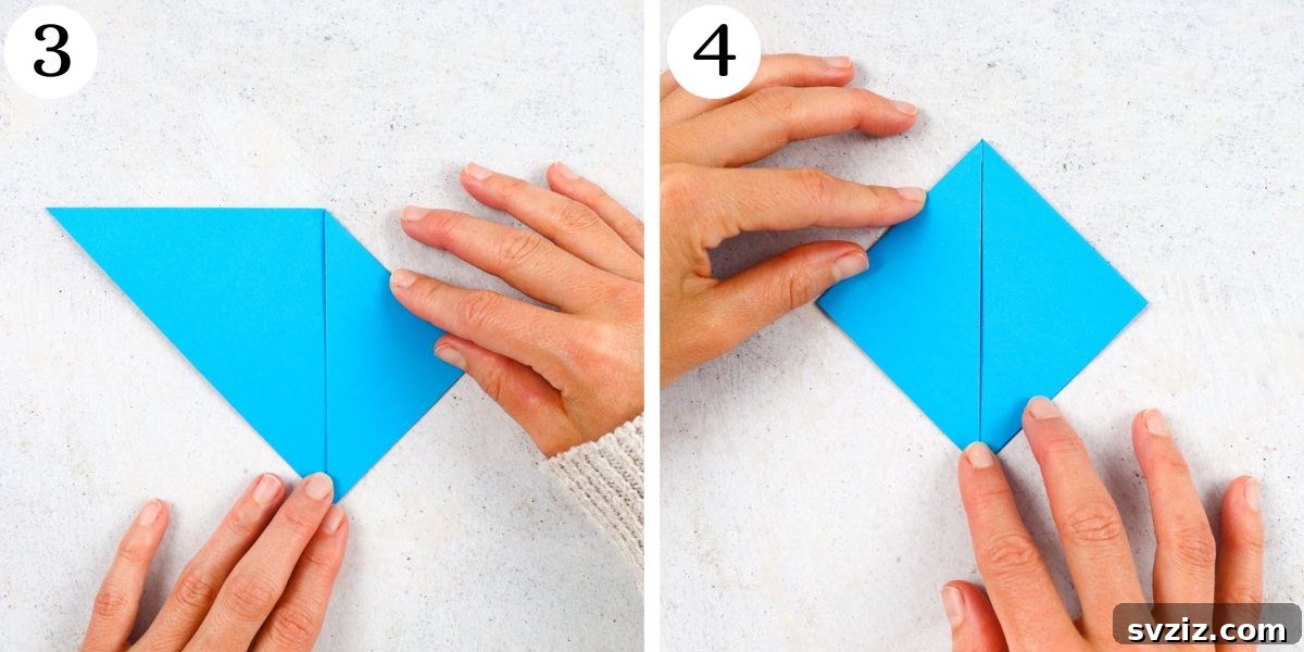 Fold the right and left corners of the triangle to meet the top point, origami corner fold