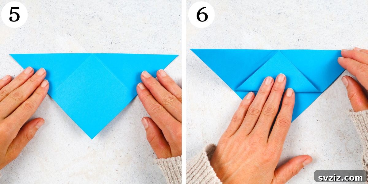 fold top flap of the triangle point upward, creating a pocket for the bookmark