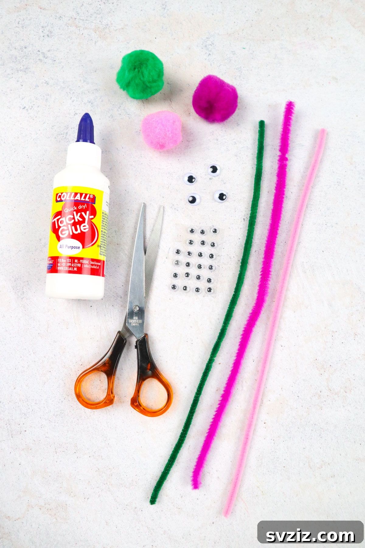 Craft supplies for making pipe cleaner puppets laid out on a table, including pipe cleaners, pom poms, googly eyes, glue, and scissors.
