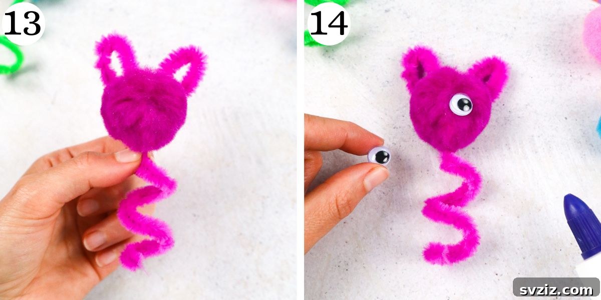 A pom pom head with two small dots of glue ready for googly eyes.