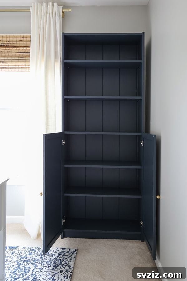 IKEA Billy Bookcase hack with shiplap backing and brass knobs