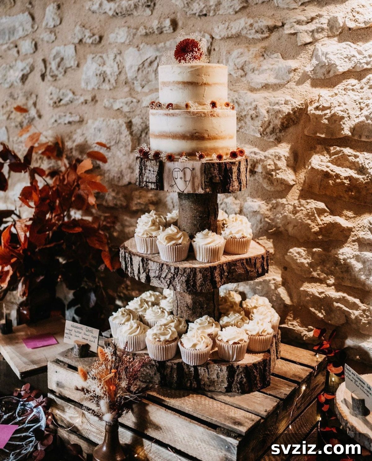 31 Adorable Rustic Wedding Ideas 31 Two-Tier Wedding Cake with Coordinating Cupcakes on Rustic Stand