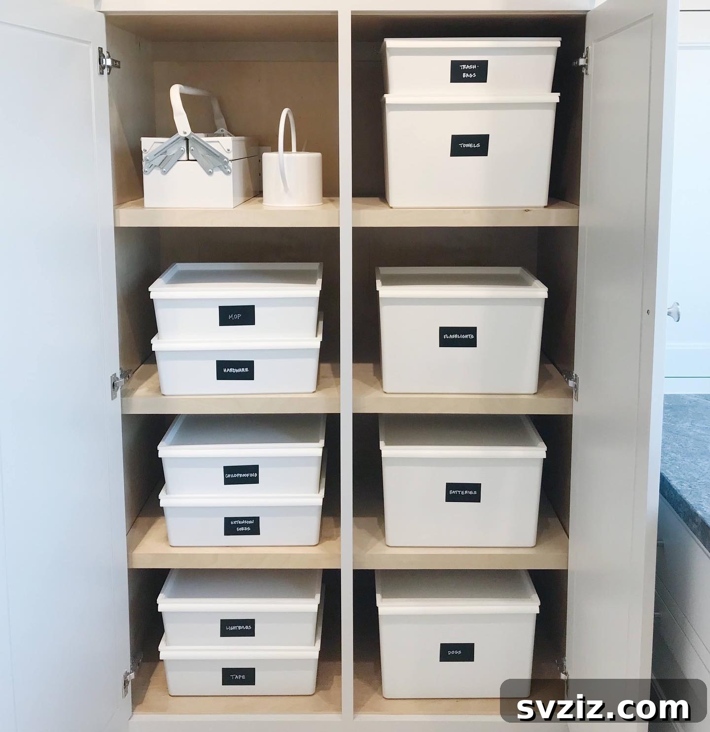 27 Smart Solutions for Organizing Clutter 19 Storage Cabinet Bins - A cabinet interior organized with uniform bins on shelves, labeled for various household categories like 'Medicine' and 'Cleaning,' showcasing tidy storage.