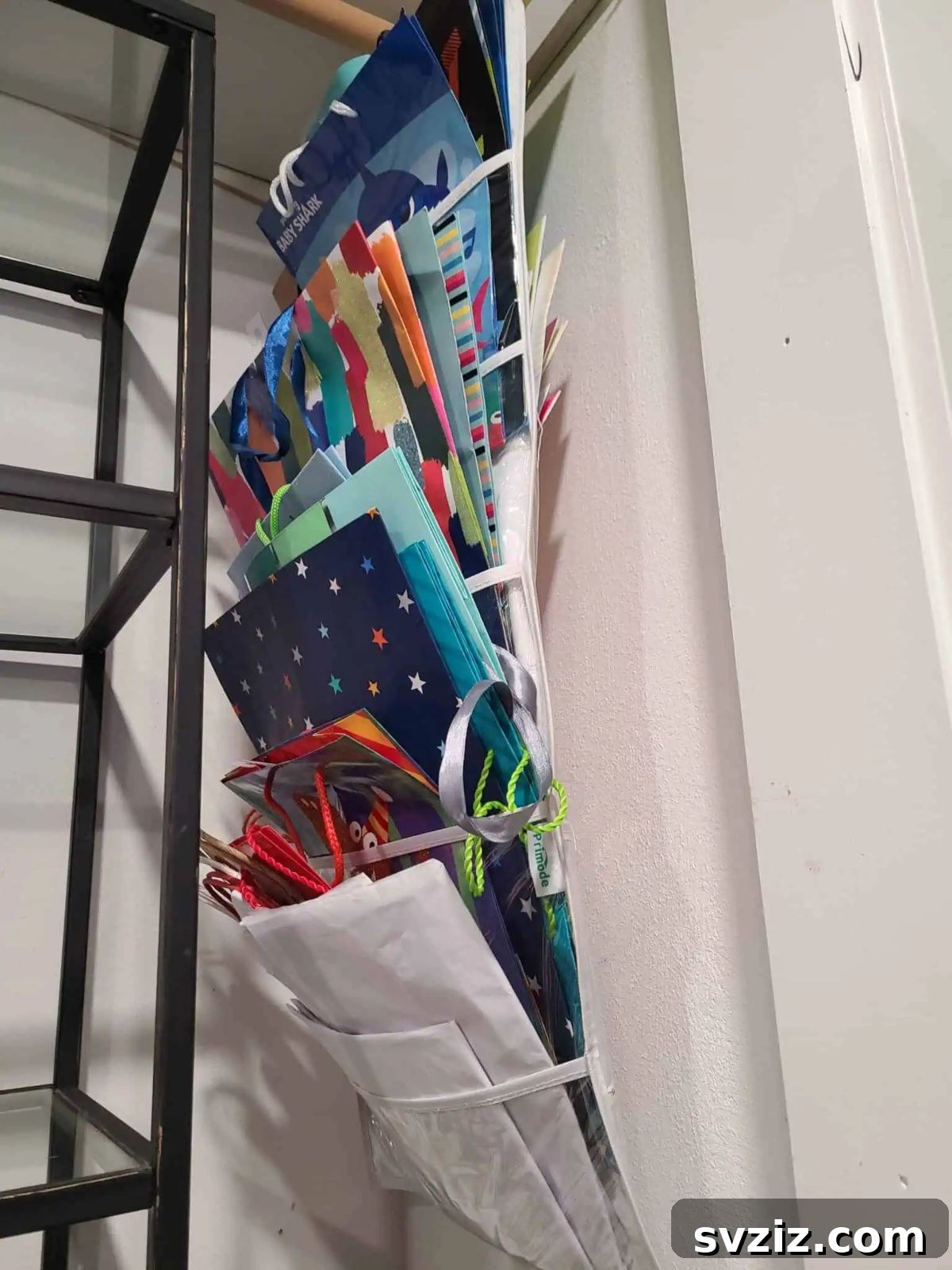 27 Smart Solutions for Organizing Clutter 29 Hanging Gift Bag and Gift Wrap Organizer - A closet door with a hanging organizer specifically designed for gift bags, wrapping paper rolls, and ribbons, keeping them neat and crease-free.