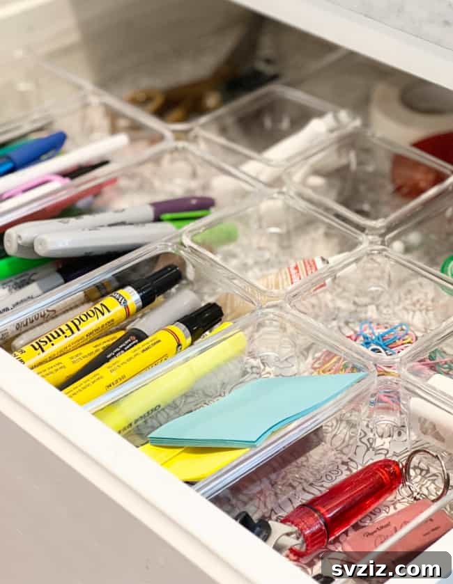 27 Smart Solutions for Organizing Clutter 4 Acrylic Junk Drawer Organizers - A kitchen drawer neatly organized with clear acrylic bins, holding various small kitchen tools and accessories.