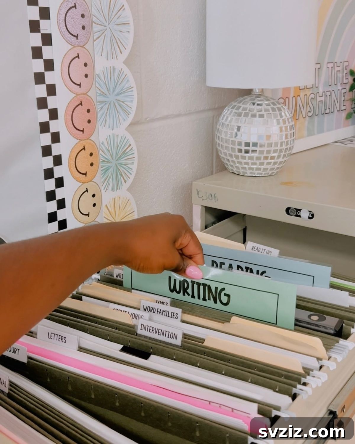 17 Genius School Office Organization Hacks 8 Compact hanging file cabinet mounted on a wall, used for storing student files and backup resources.