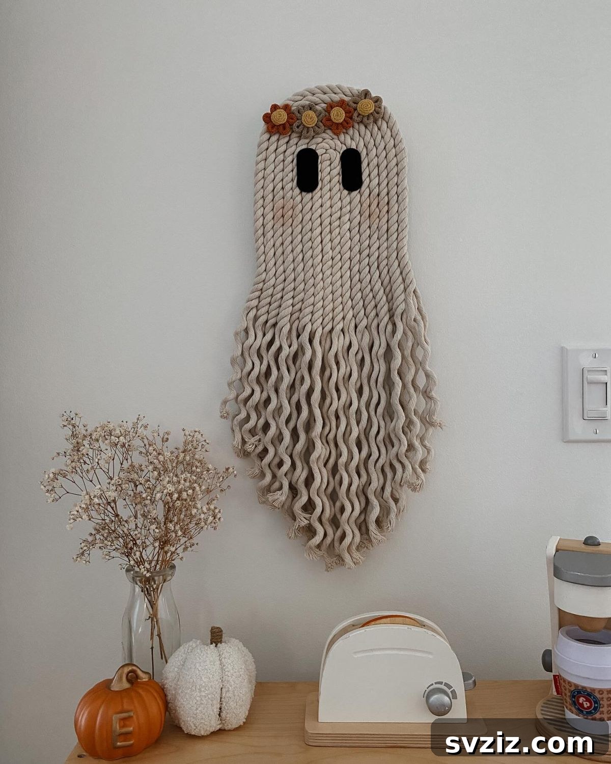 Spine-Chilling Interiors: 31 Scary Halloween Decor Ideas 26 ghost wall hanging