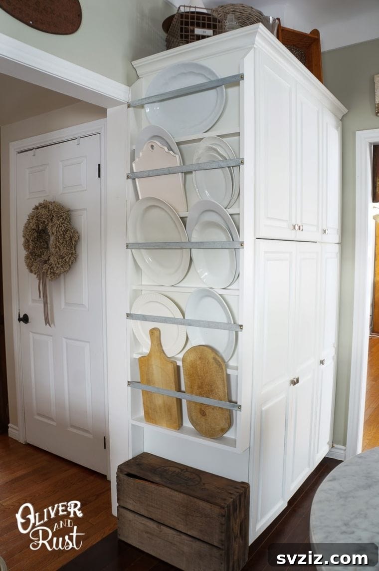 DIY vertical serving platter and cutting board storage in kitchen