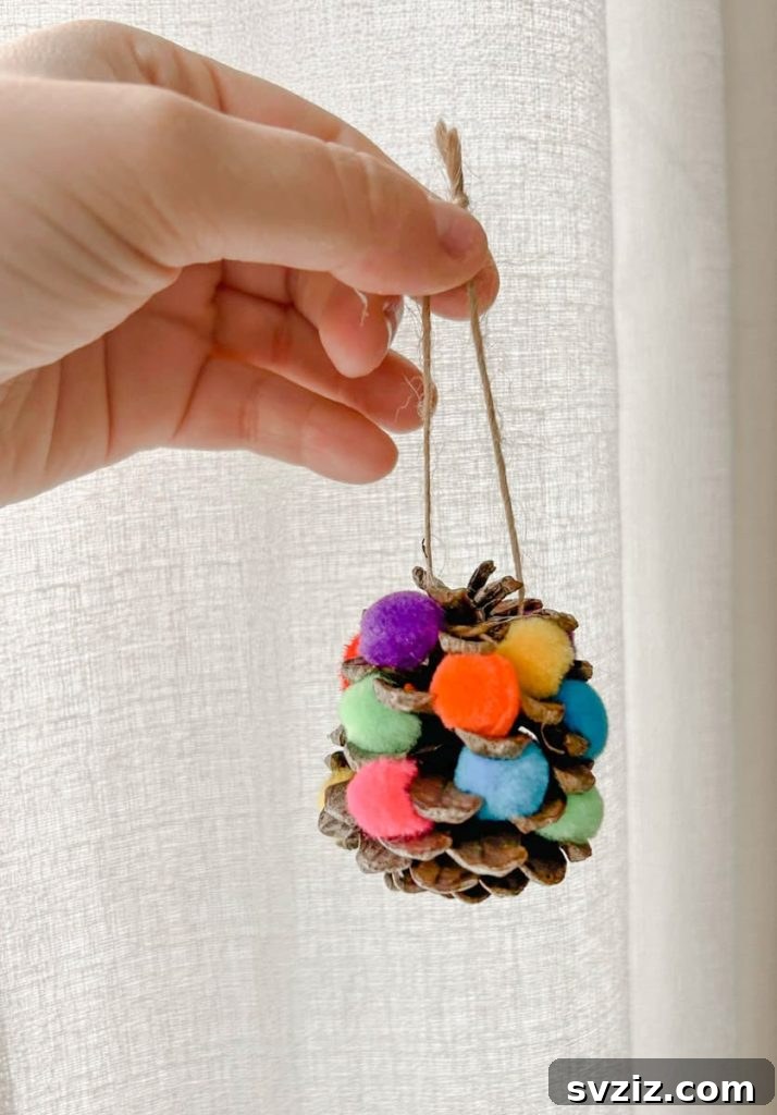 Delightful Pinecone Holiday Projects 22 Kids activity pinecone Christmas wreaths and ornaments with colorful pom poms