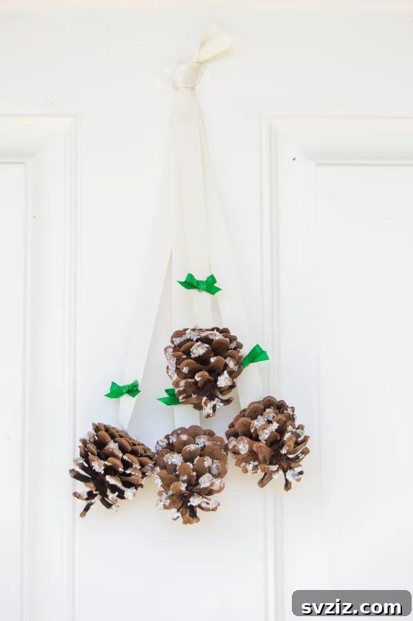 Delightful Pinecone Holiday Projects 6 Easy snowy pinecone door hanger for holiday entry