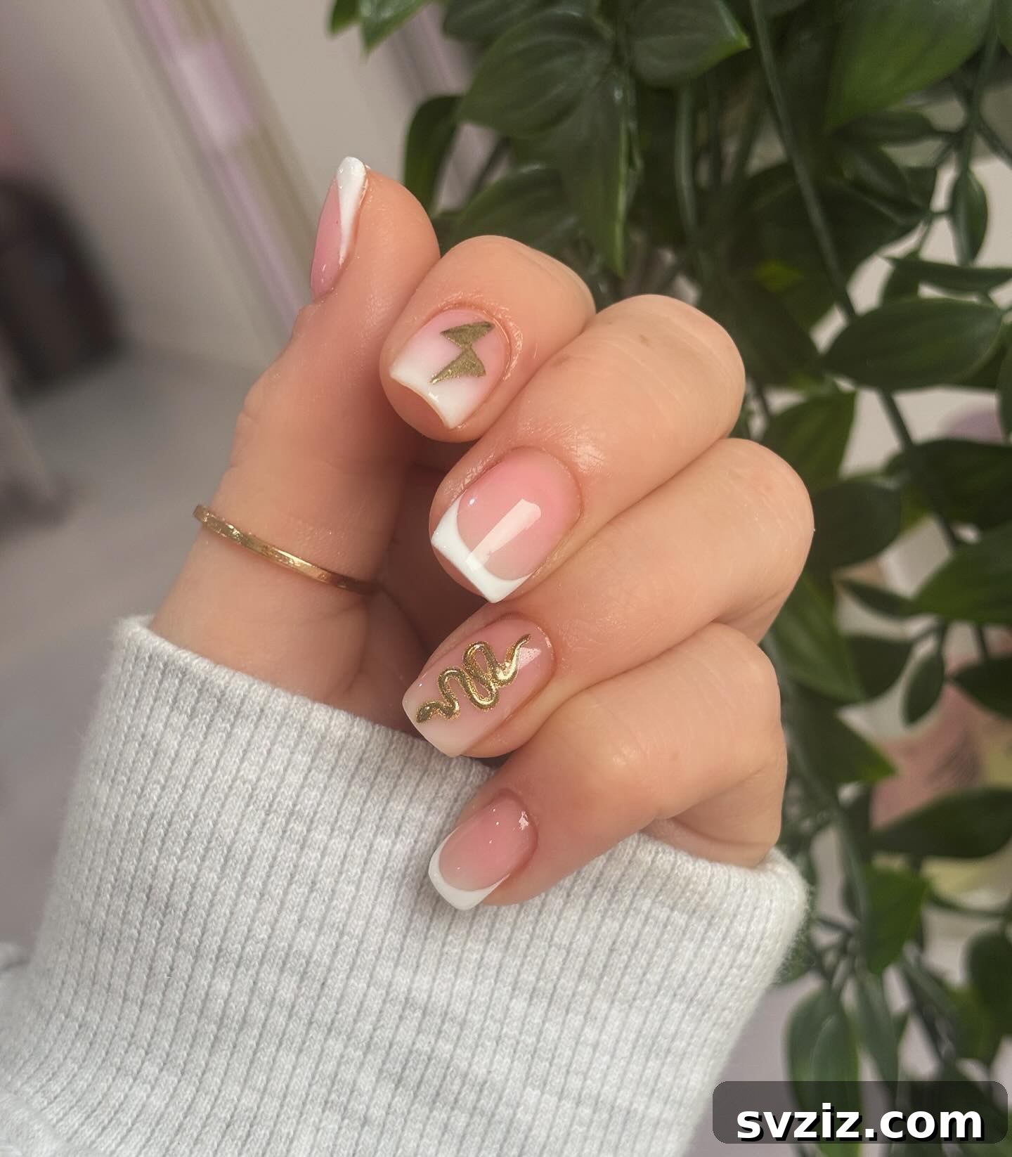 Golden snake design on neutral short nails