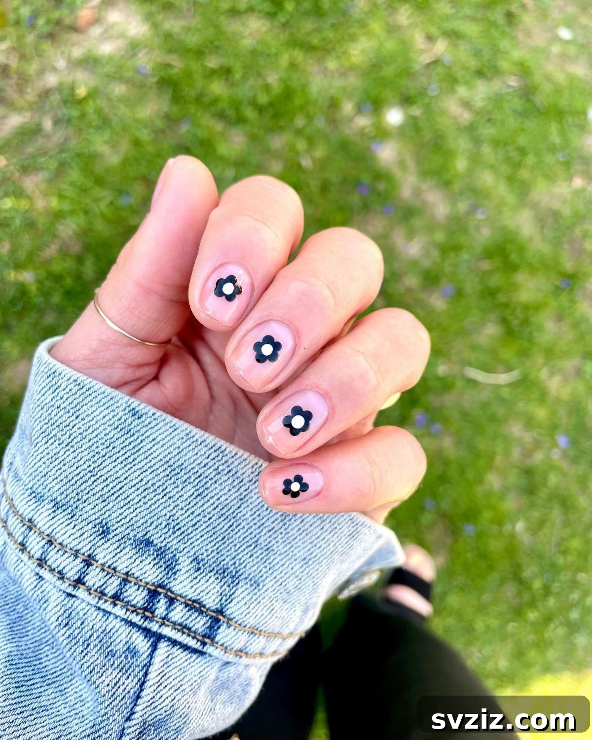 Minimalist black flower nail art on short nails