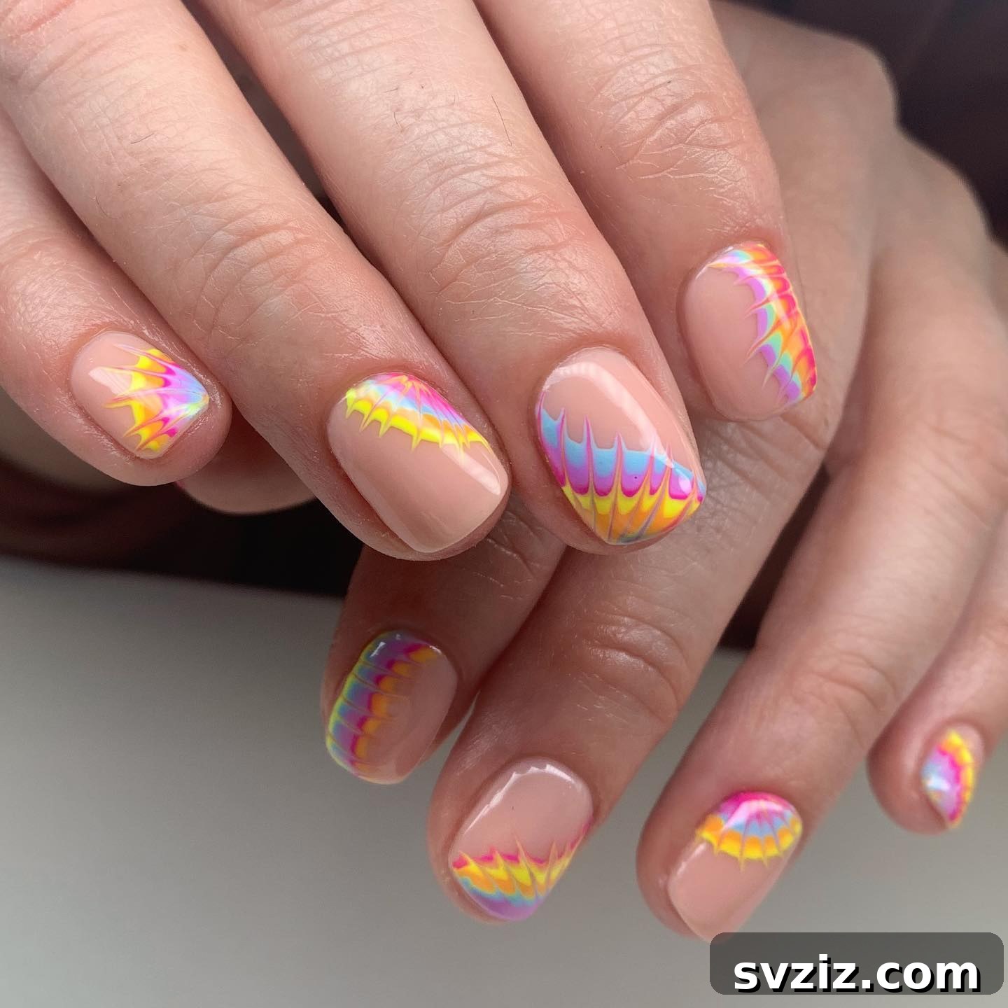 Colorful tie-dye nail art on short nails