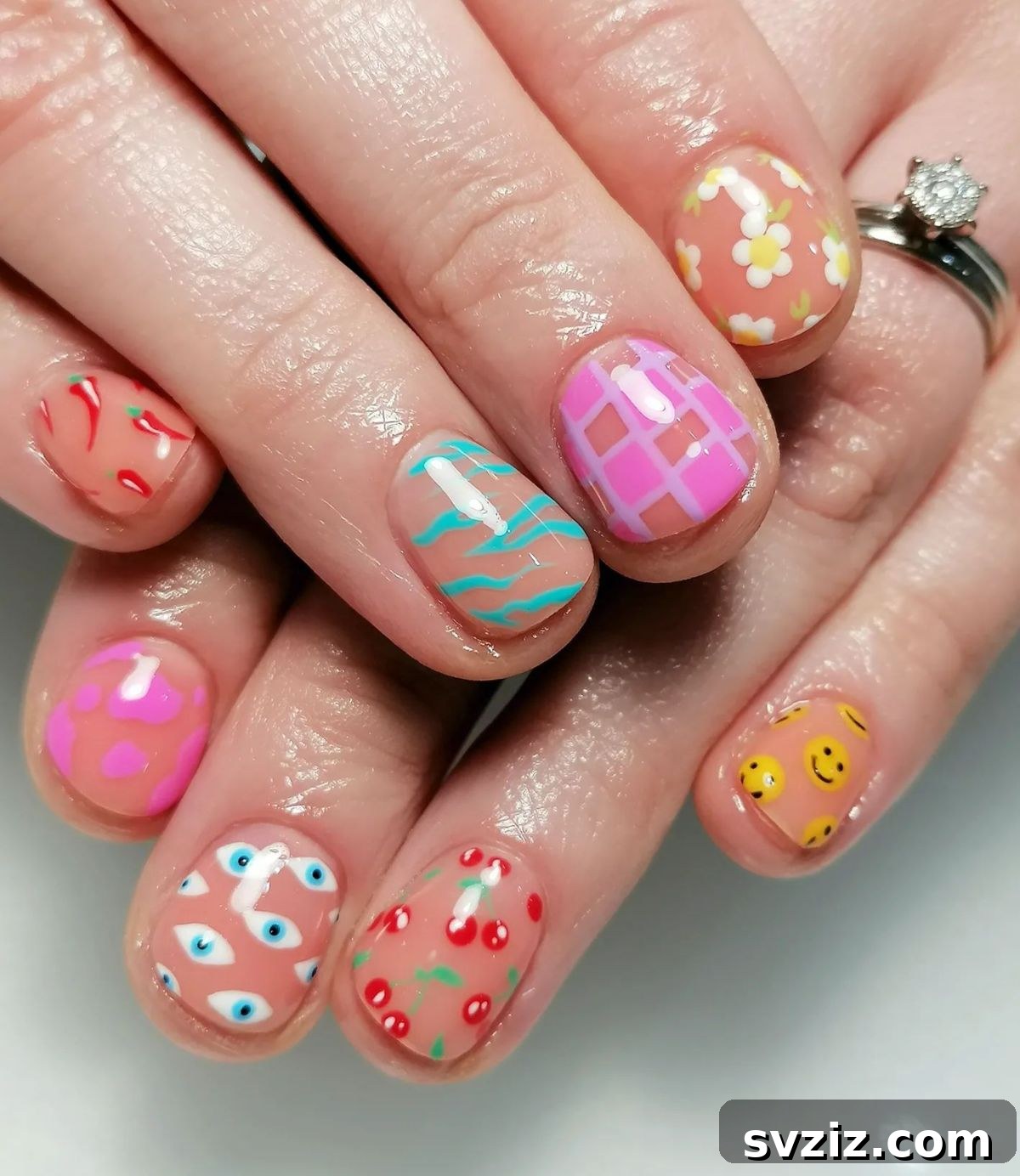 Mixed emoji, chili pepper, and floral nail art on short nails