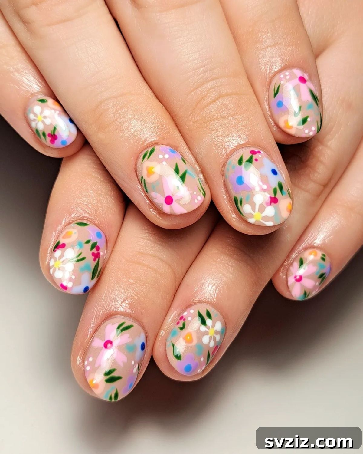 Bright floral nail art on short nails with pastel colors