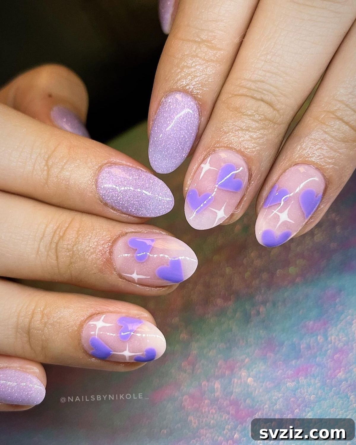 Swirling purple and lilac nail art on short nails, resembling a storm