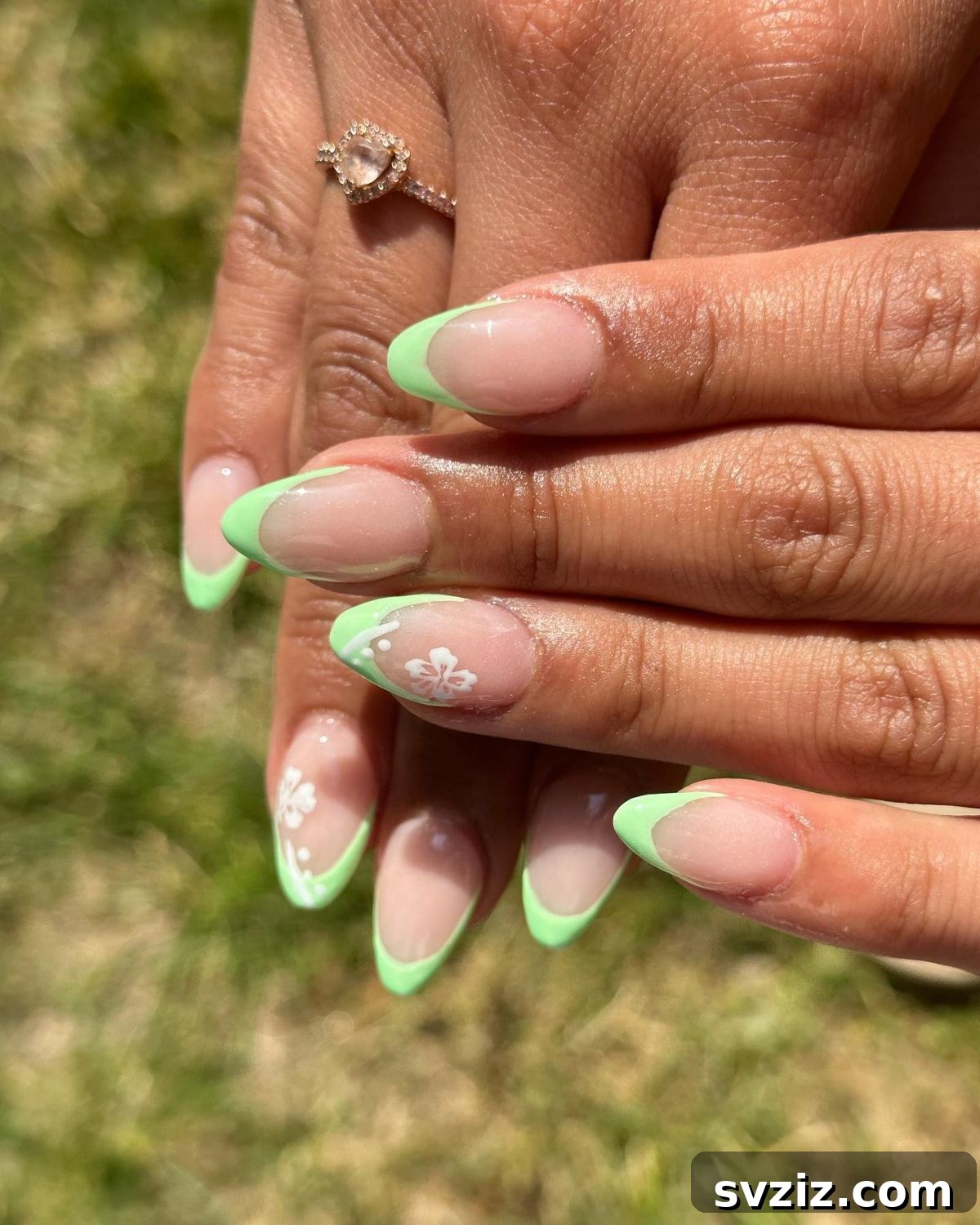 Almond French tip nails in green on short to medium length