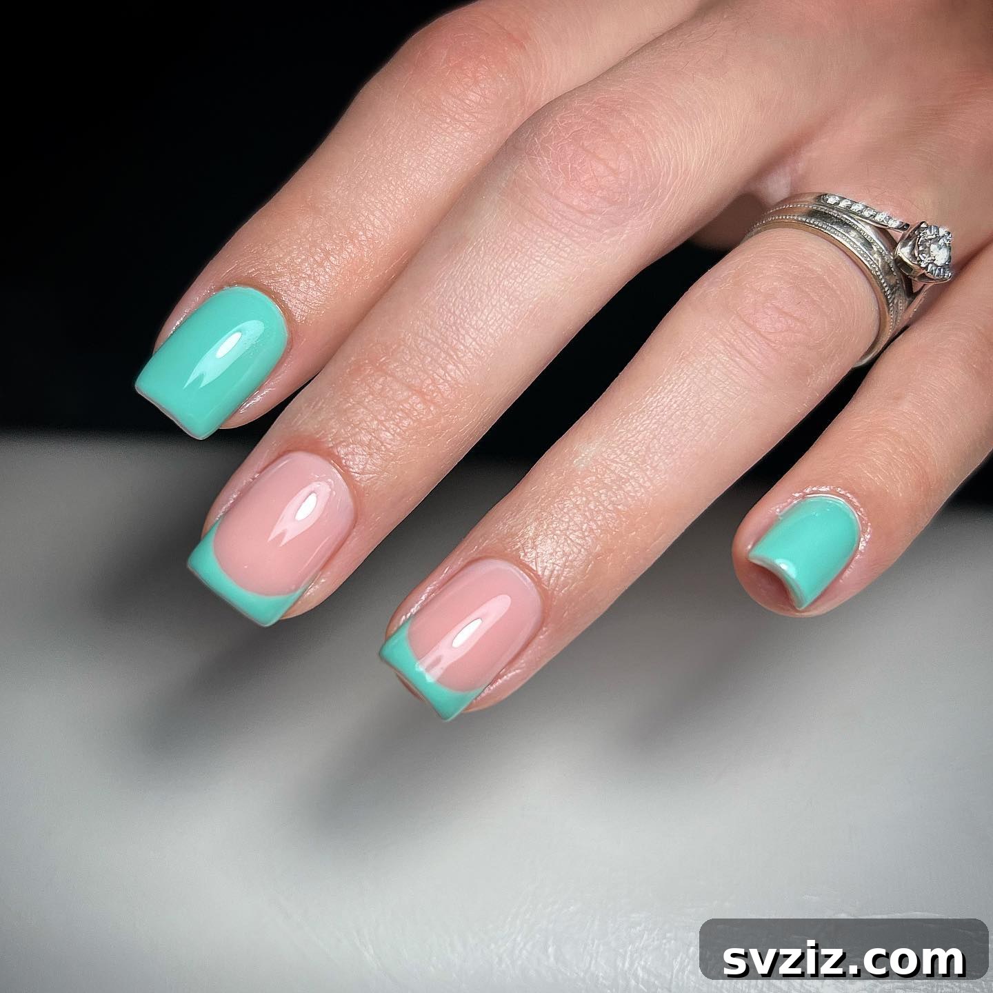 Square shaped short nails with turquoise and nude polish