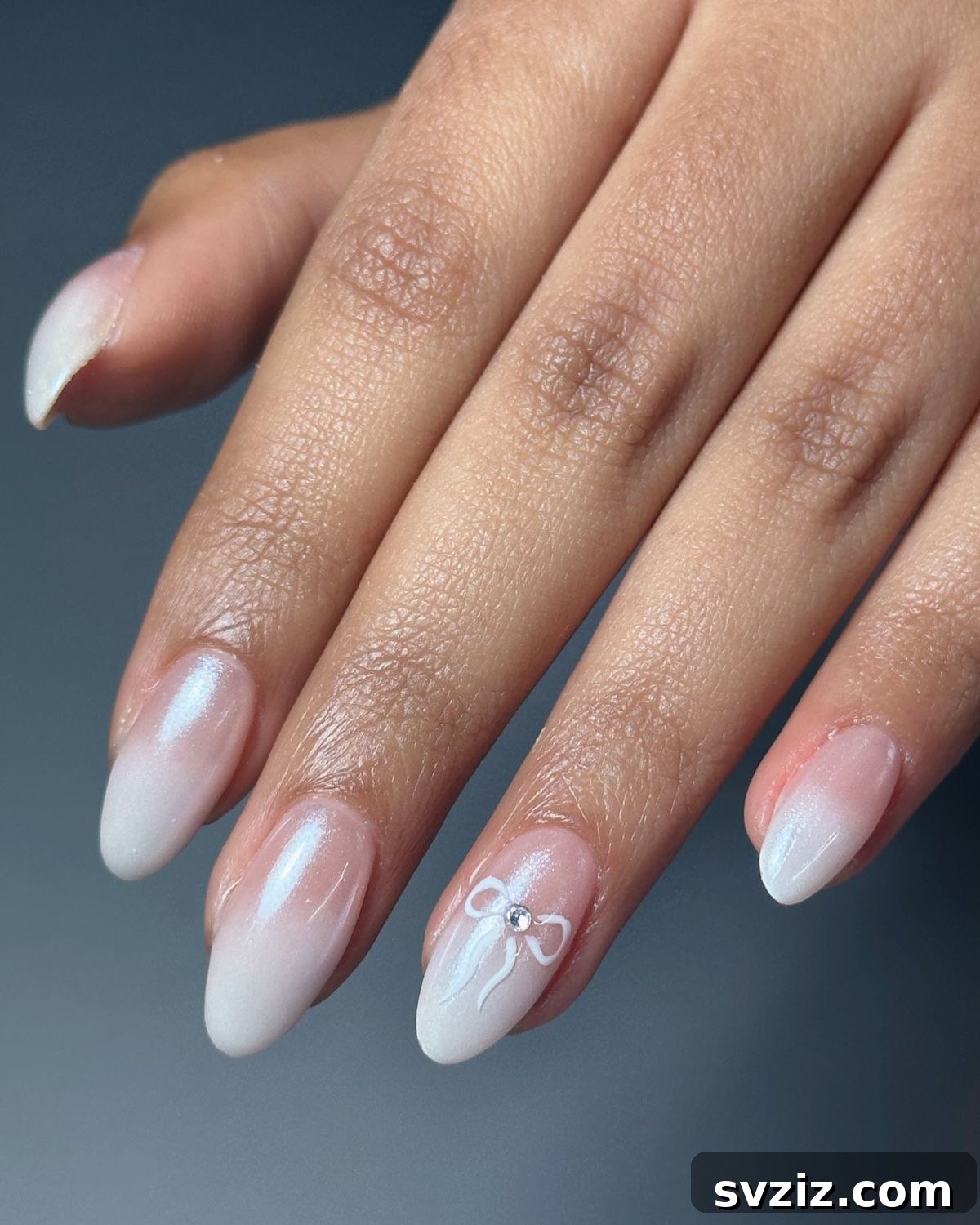 Stunning Bridal Nail Art Inspiration 24 Stunning ombre French manicure with a chrome finish and painted bow accent