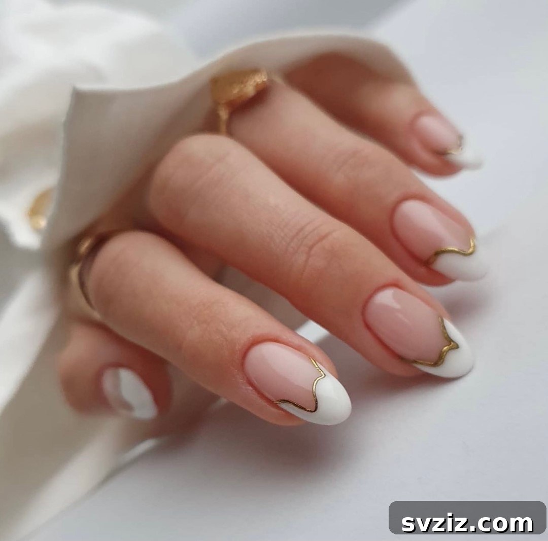 Stunning Bridal Nail Art Inspiration 32 Modern white and gold French manicure with crisp, clean lines