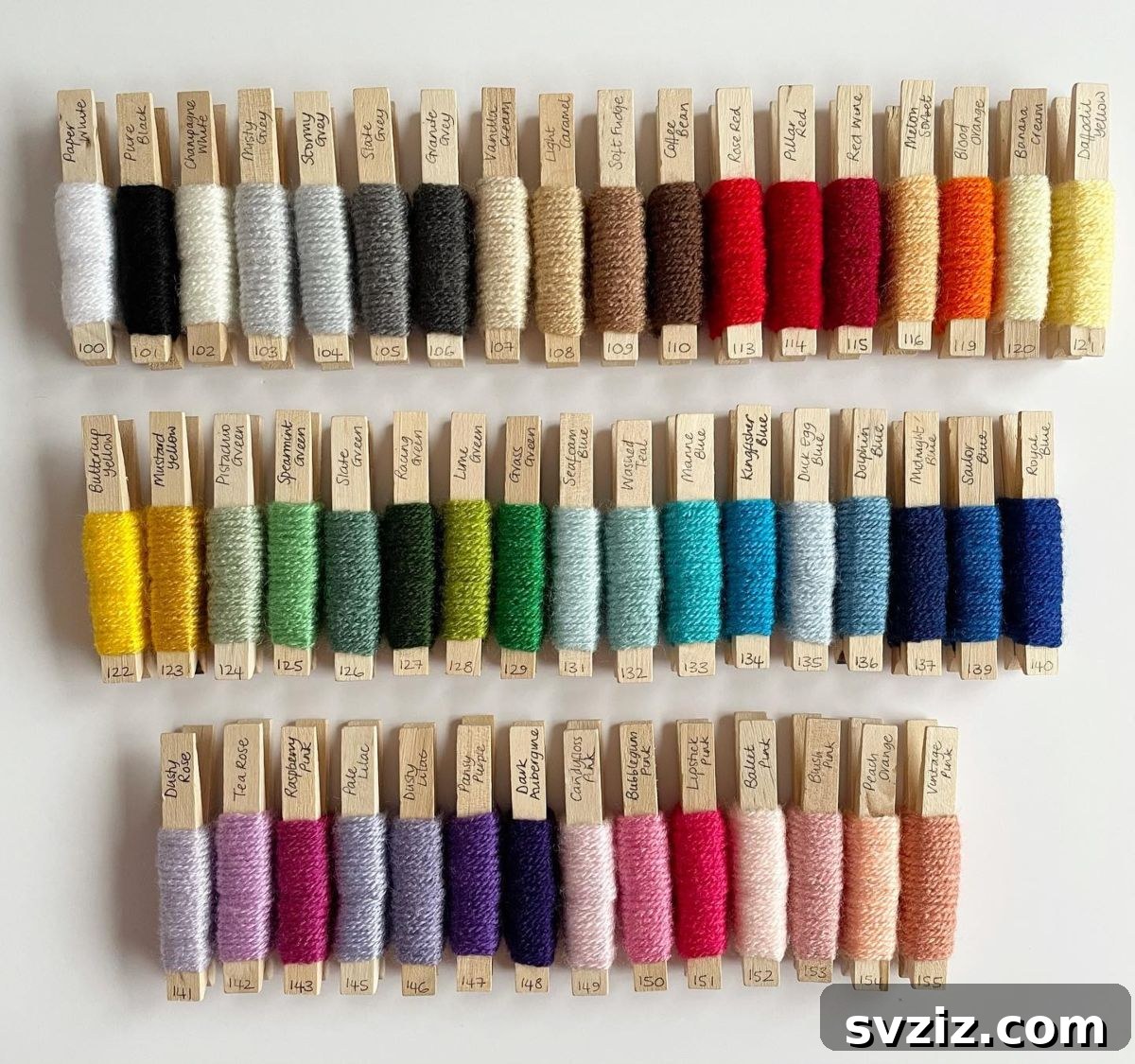 21 Ingenious Yarn Storage Solutions 16 Yarn color samples neatly hung on a pegboard or wall, providing easy visual access.