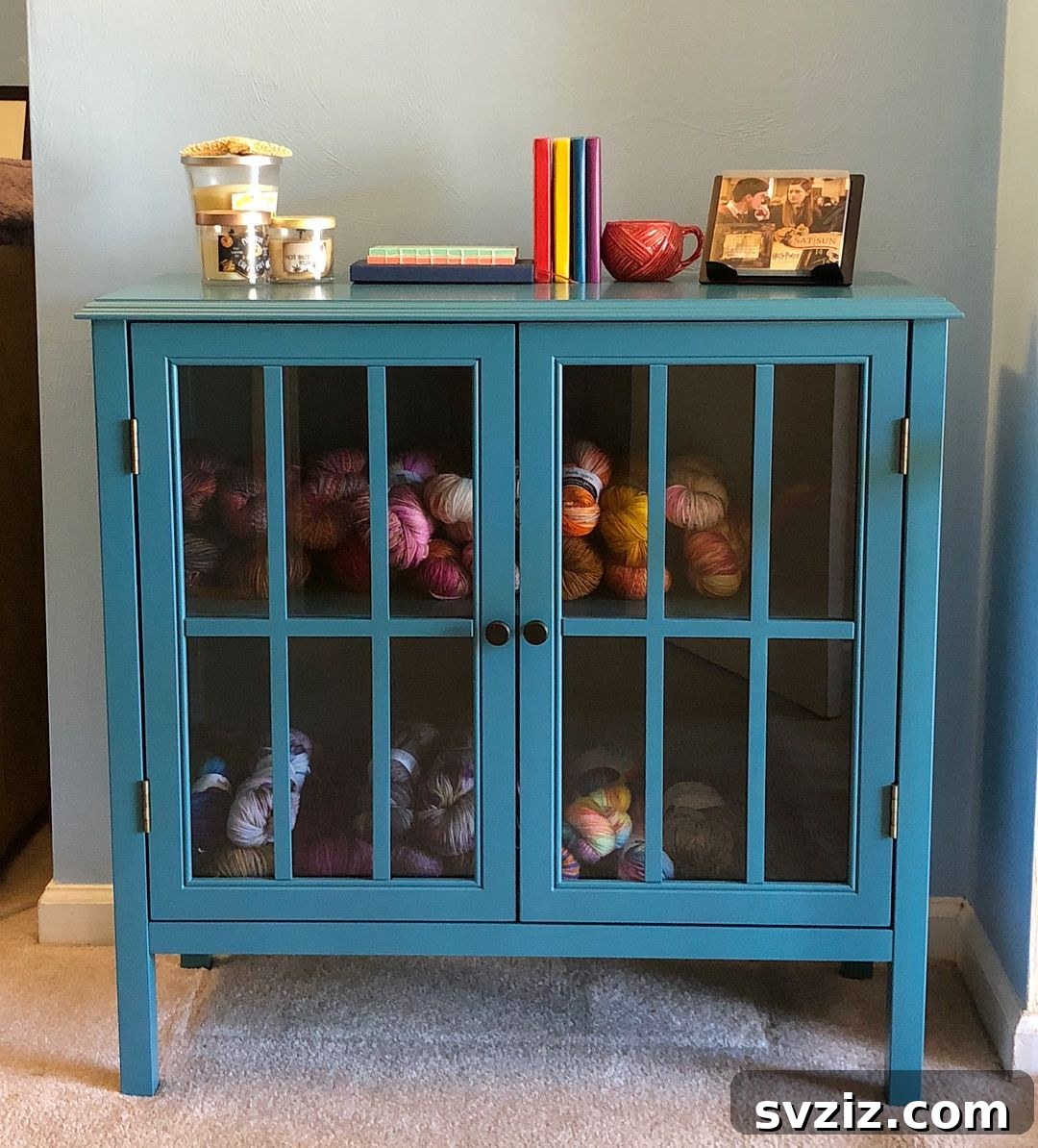 21 Ingenious Yarn Storage Solutions 21 A charming yarn cabinet with clear doors, elegantly displaying an organized yarn collection.
