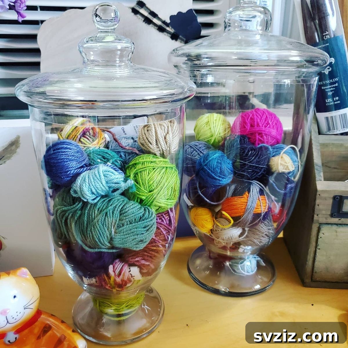 21 Ingenious Yarn Storage Solutions 6 Yarn stored in clear glass jars, neatly organized by color and weight.