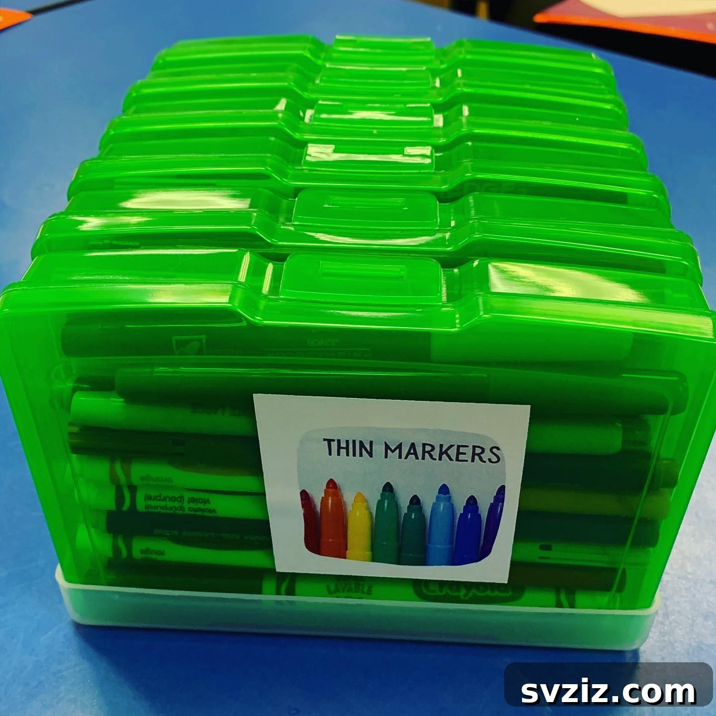 Unlock Creativity: Smart Organization for Your Art Studio 12 Individual marker organizers for each table in an art classroom, containing full sets of markers in clear plastic containers. This system allows for easy distribution and collection of art supplies, promoting order and accessibility during creative activities.
