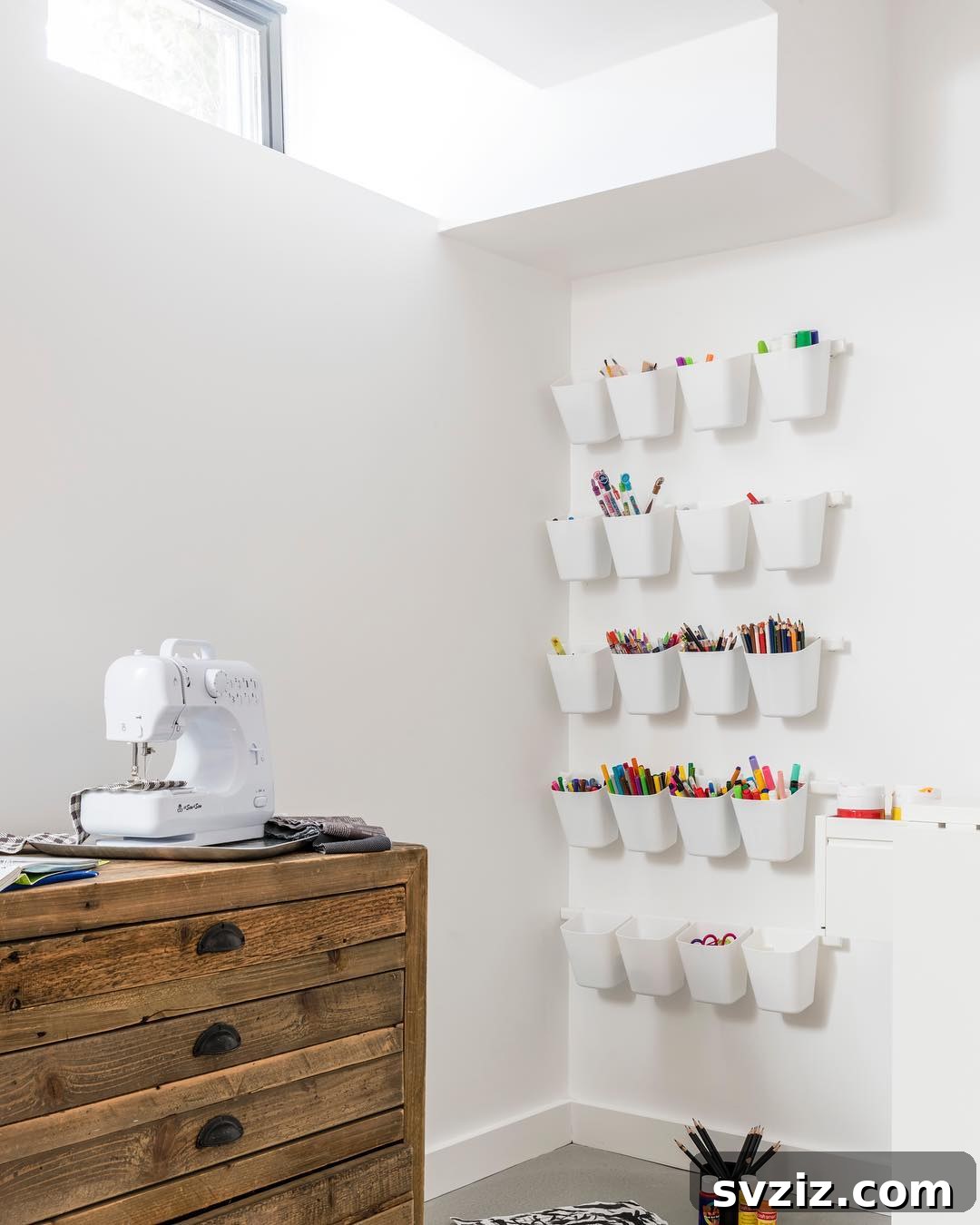 Unlock Creativity: Smart Organization for Your Art Studio 19 Hanging plastic bins mounted on a wall in an art room, providing additional space-saving storage for markers, pencils, and pens. This vertical organization solution maximizes wall space, keeping frequently used art supplies accessible and off countertops.