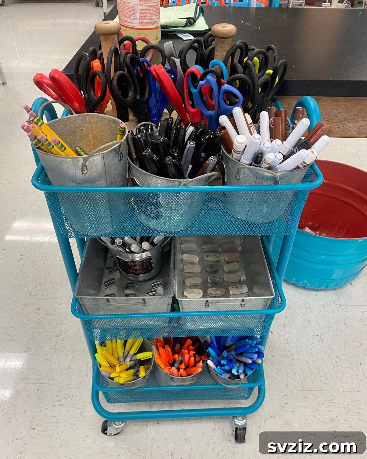 Unlock Creativity: Smart Organization for Your Art Studio 6 A rolling supply cart filled with various art materials like paint, markers, and brushes, offering mobile and flexible storage for an art classroom. This versatile cart allows teachers to bring supplies directly to students, enhancing accessibility and organization.