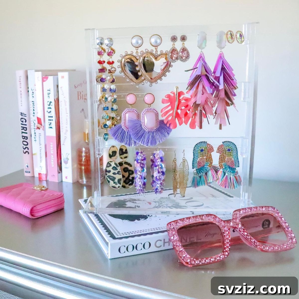 21 Ingenious Vanity Organization Hacks for a Tidy Space 15 Clear acrylic display stand showcasing several pairs of statement earrings.