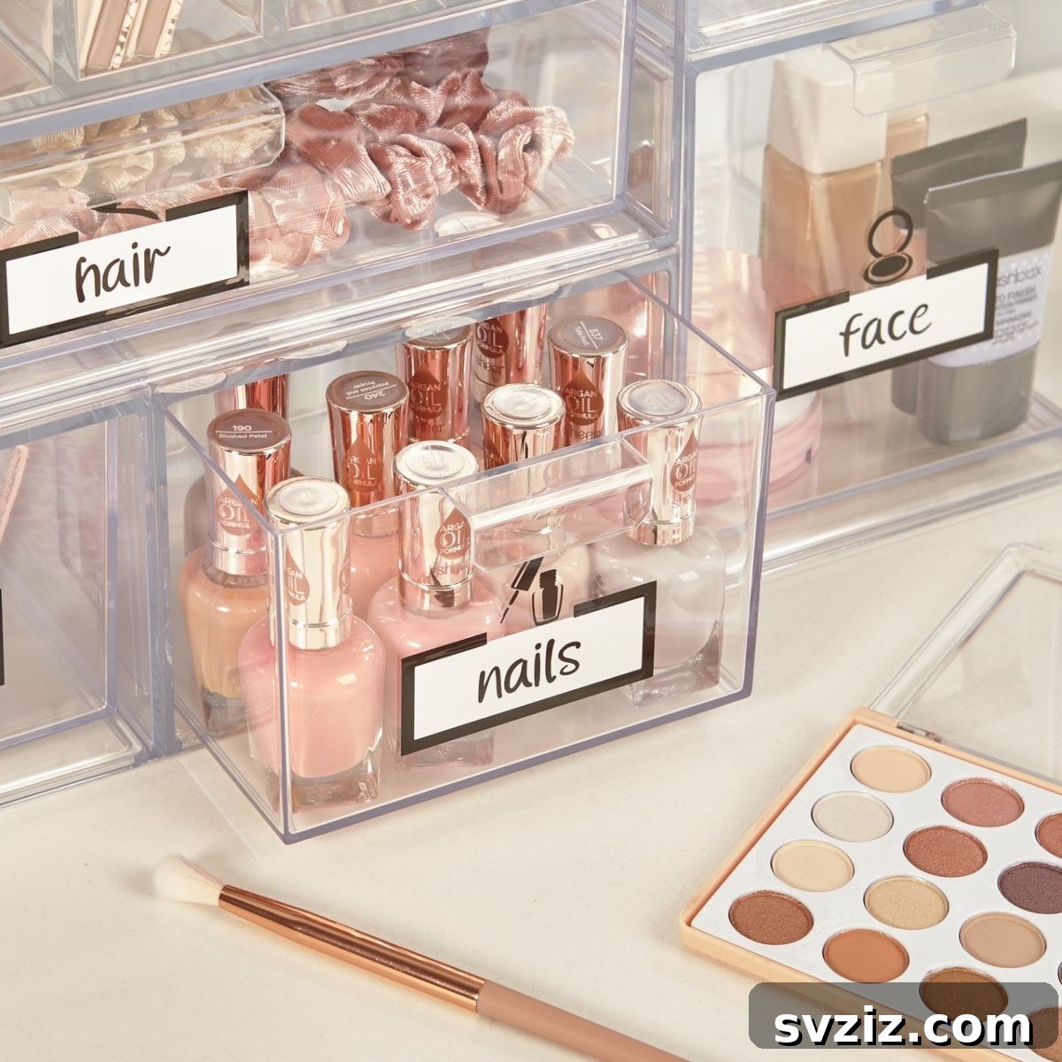 21 Ingenious Vanity Organization Hacks for a Tidy Space 3 Clear acrylic cosmetics organizer with multiple drawers filled with makeup on a vanity.