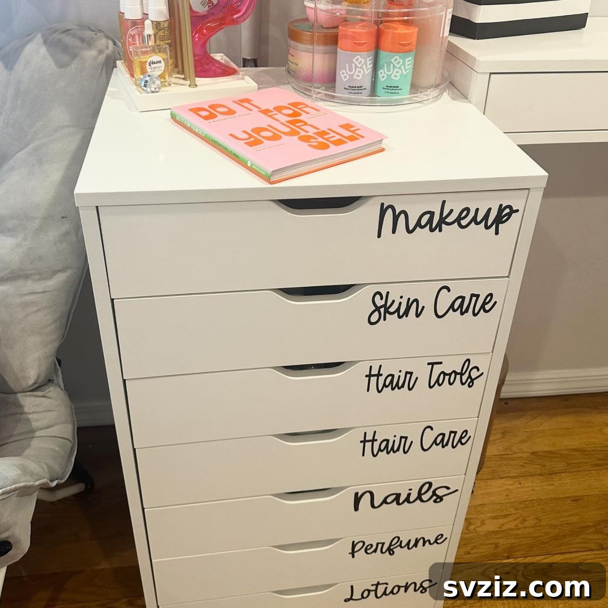 21 Ingenious Vanity Organization Hacks for a Tidy Space 23 A tall, slender chest of white drawers used as a vanity storage solution, with labels on each drawer.