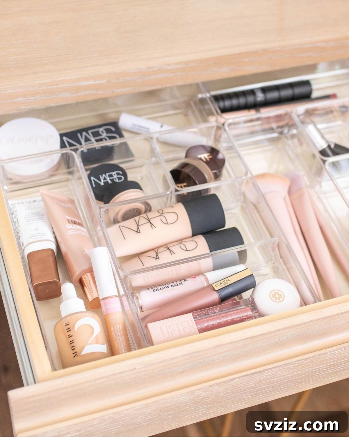 21 Ingenious Vanity Organization Hacks for a Tidy Space 5 Vanity drawer featuring clear acrylic organizers neatly dividing makeup products.