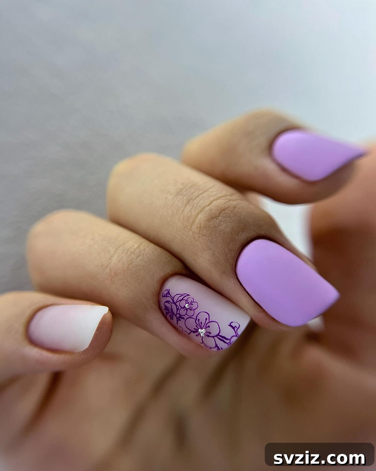31 Chic Short Matte Nail Designs to Try Now 8 Elegant short matte purple nails adorned with a stunningly detailed floral design.