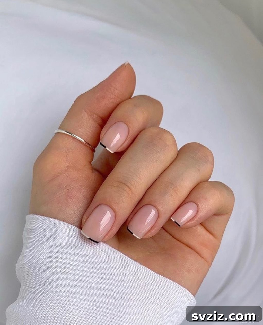 Chic Nude Nails with Minimal Black and White Tip Accents