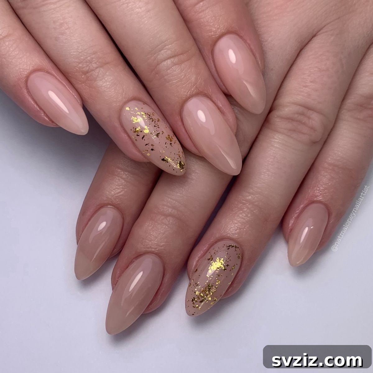 41 Effortless Nude Nail Ideas for Everyone 20 Chic nude nails featuring a subtle sparkly gold accent, embodying effortless elegance and minimalist glamor.