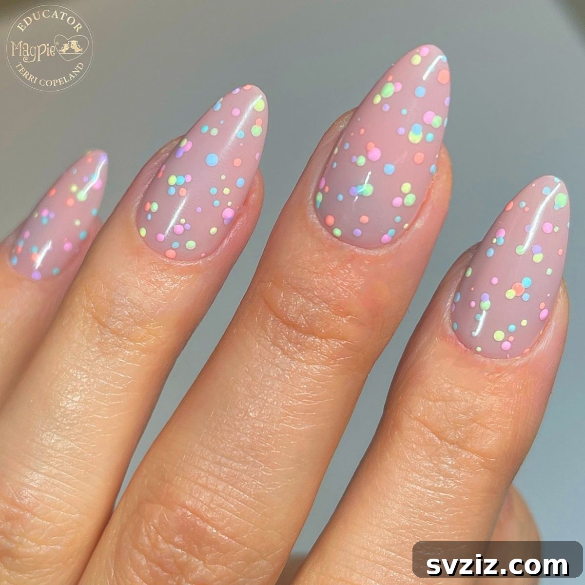 41 Effortless Nude Nail Ideas for Everyone 23 Playful nude nails featuring vibrant pops of colorful abstract designs, disproving any notion of 'boring' neutrals.