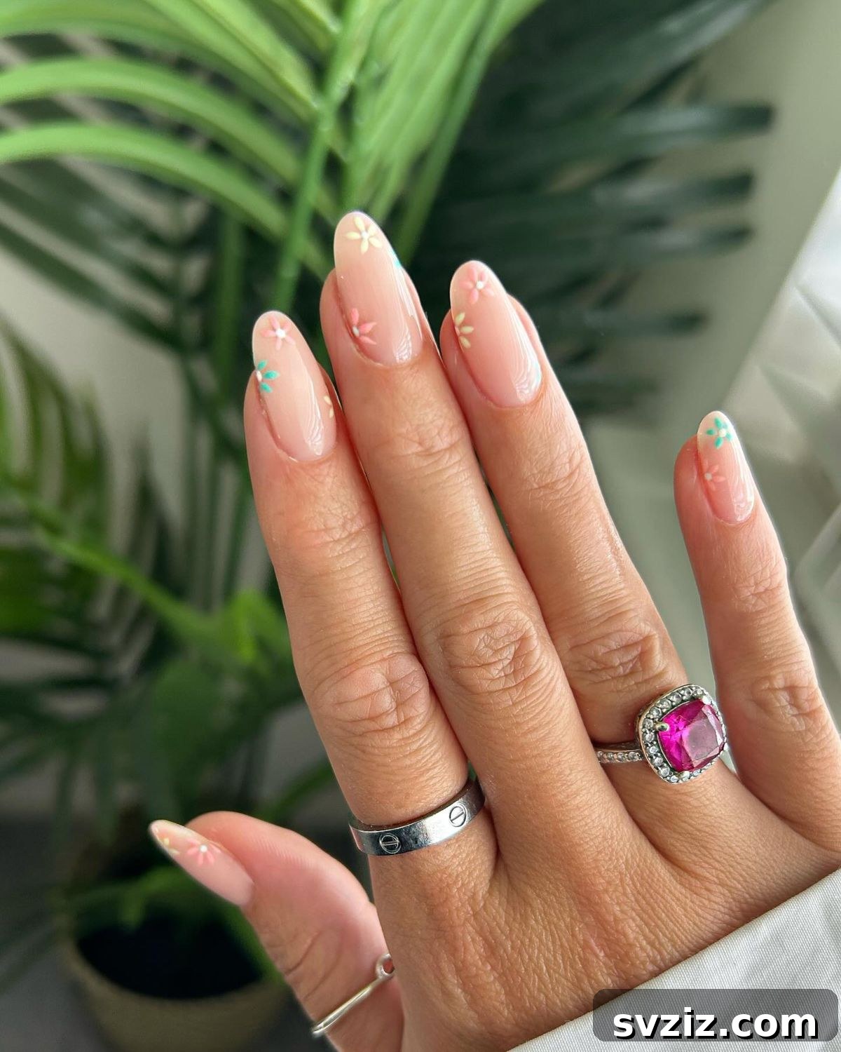 41 Effortless Nude Nail Ideas for Everyone 28 Subtle nude nails with vibrant, colorful floral designs, adding a delicate burst of nature's beauty.