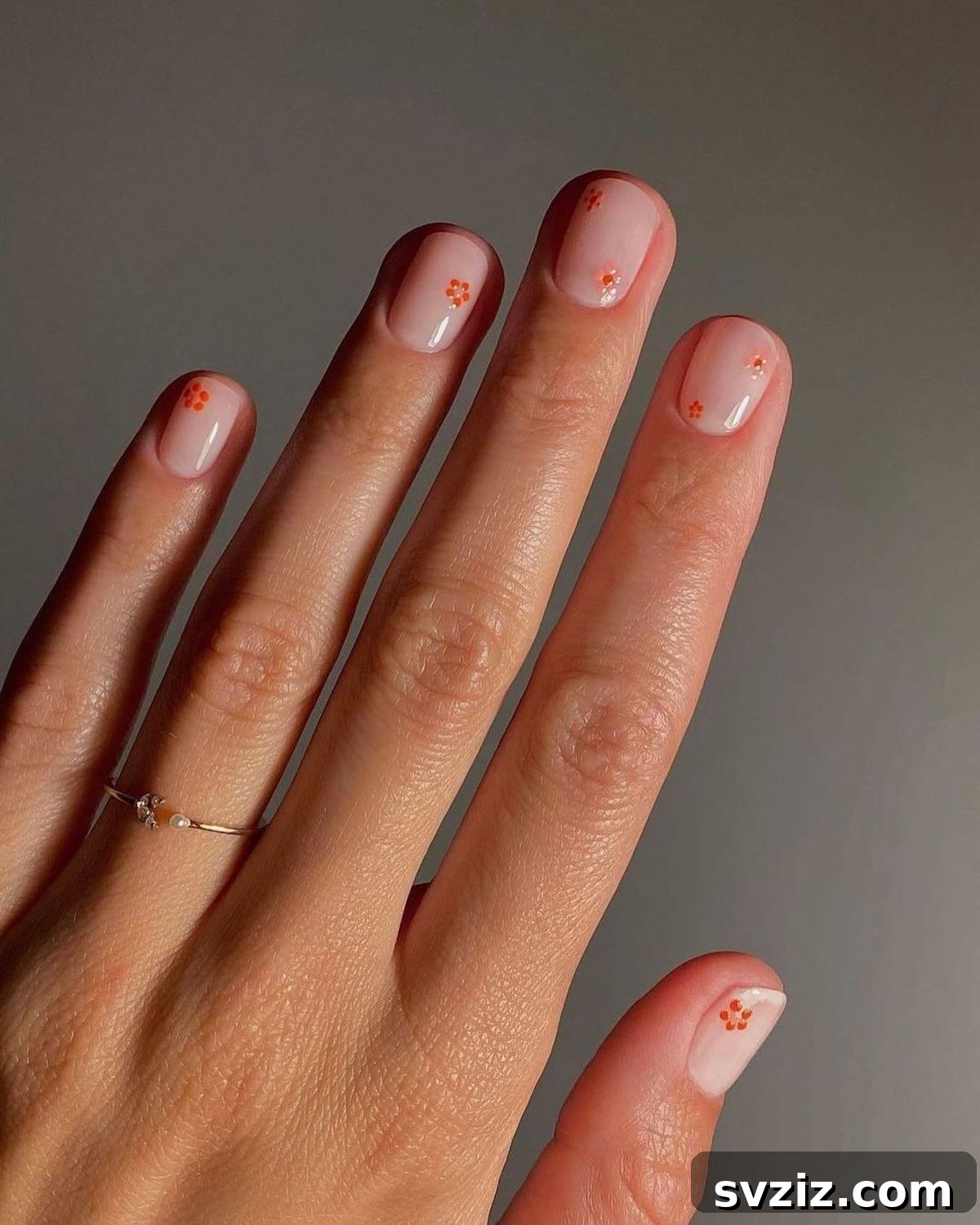41 Effortless Nude Nail Ideas for Everyone 30 Cute nude nails with simple, delicate floral accents, adding a playful and charming touch.
