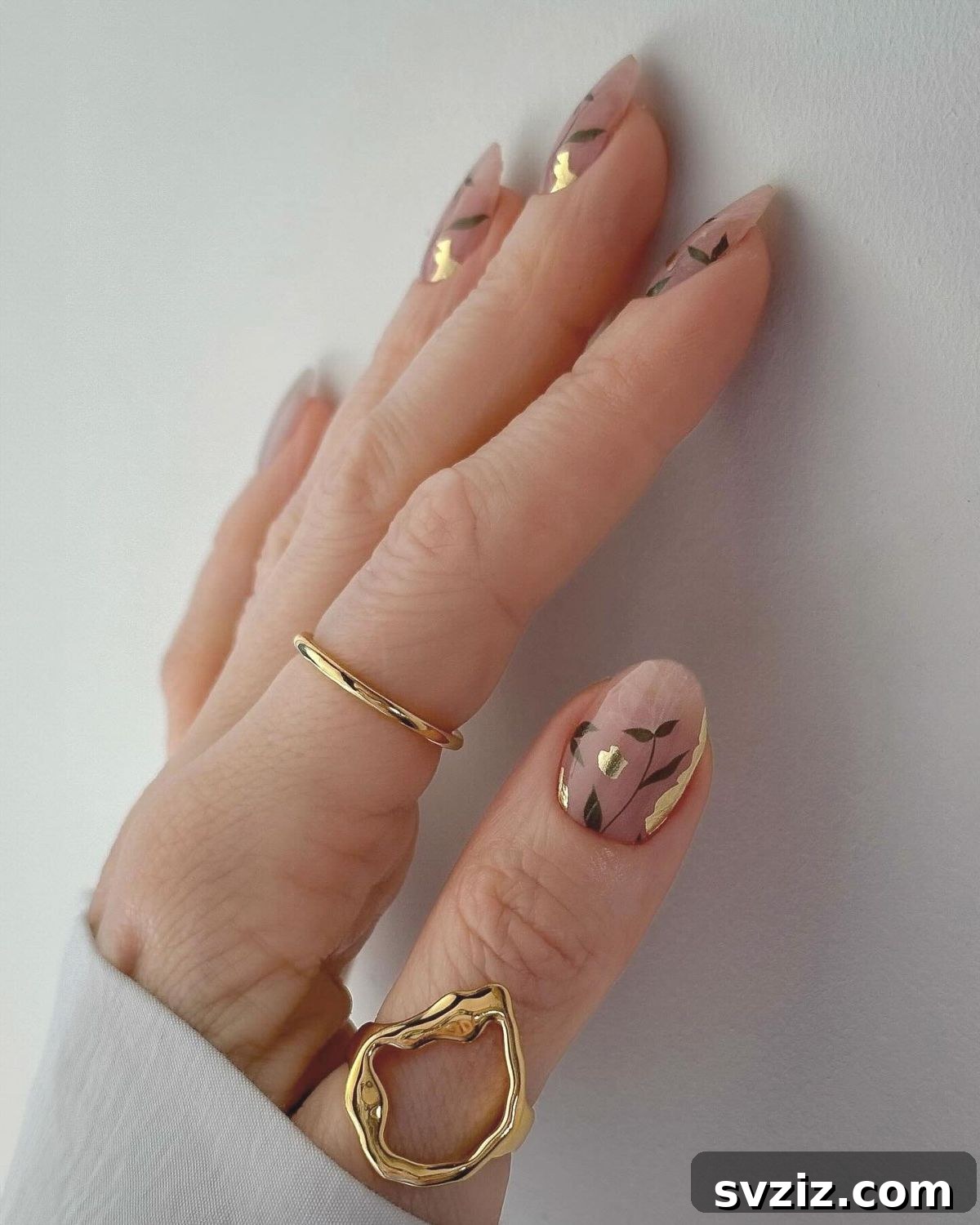 41 Effortless Nude Nail Ideas for Everyone 31 Glamorous nature-inspired nude nails featuring elegant green and gold accents for an unforgettable design.